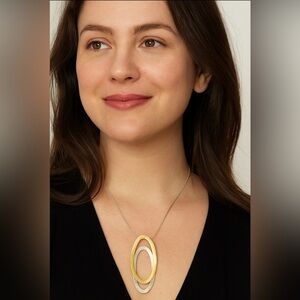 Two toned silver necklace w/gold overlay on oval pendant, long length, like new